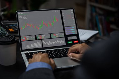 Grafik analizi, mum hattı analizi ve borsa karını rapor eden bir iş adamı..