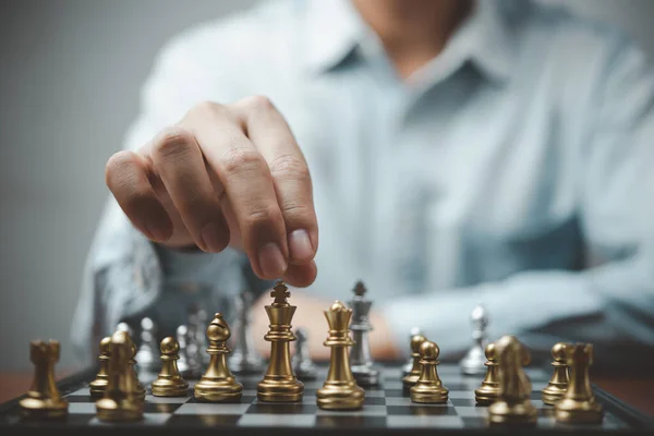 Strategic planning and goals success business idea. Businessman looking at chess at the board.