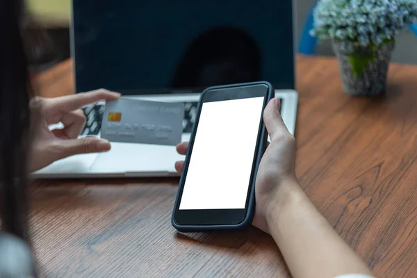 stock image woman using smartphone mock up shopping purchasing online, paying by credit card, making payment, checking balance, browsing internet banking service.