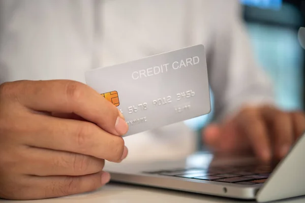 stock image Online shopping e-commerce or internet banking concept.Man hand holding credit card and using laptop.Business finance payment and accounting.