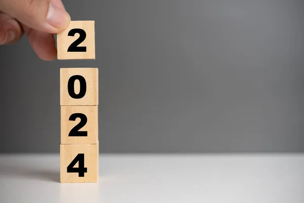 wood cube block 2024 business growth concept. New year business goals, plan and strategy.