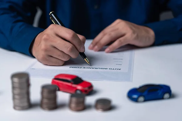 Signing a car purchase or lease agreement. Car loan and insurance concept.