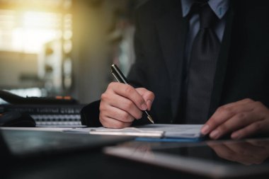 Business person Writing contract law and paper work for business and finance, write document, complete job application forms, contract real estate and insurance concept.	