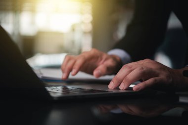 Bir dizüstü bilgisayarda daktilo eden işadamı internette dijital veri üzerinde çalışıyor.