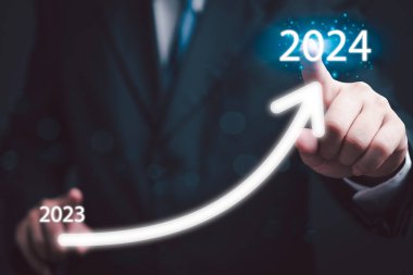 loading progress bar to 2024 Businessman tounching arrow investment and planning marketing finance and target growth success.	