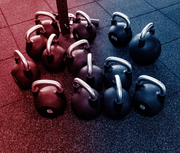 Kettlebells on Gym Floor. Neon color filter. Sport theme poster, greeting cards, headers, website and app