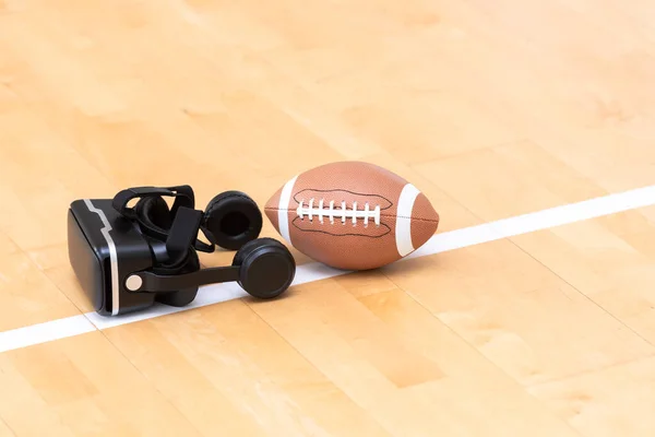 Interactive glasses and American football ball in a physical education lesson. Horizontal interactive sport theme poster, greeting cards, headers, website and app