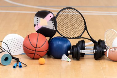 Sports equipment, rackets and balls on hardwood court floor with. Horizontal education and sport poster, greeting cards, headers, websit