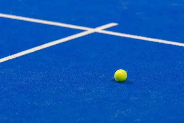 Yellow tennis ball in court on blue turf. Horizontal sport poster, greeting cards, headers, website
