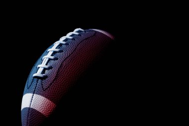 American football ball close up on black background. Horizontal sport theme poster, greeting cards, headers, website and app clipart