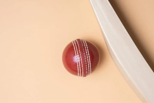 Cricket bat and red balls on green background. Horizontal sport theme poster, greeting cards, headers, website and app