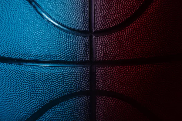 Closeup detail of blue and red basketball ball texture background. Horizontal sport theme poster, greeting cards, headers, website and app