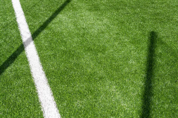 stock image Green synthetic grass sports field with white line shot from above. Soccer, hurling, lacrosse, rugby, football, baseball sport concept