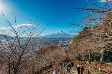 Fujiyoshida, Japonya - 14 Aralık 2023: Fujiyoshida Dağı üzerinden Fuji Dağı manzaralı bir manzaraya çıkan insanlar.