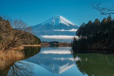 Fuji Dağı 'nın yakınında, karla kaplı tepeler ve sürüklenen bulutlarla parlıyor..