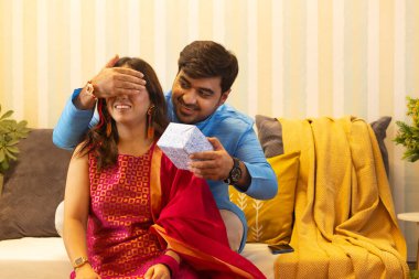 Kardeş, Raksha Bandhan vesilesiyle kız kardeşine sürpriz hediye veriyor.