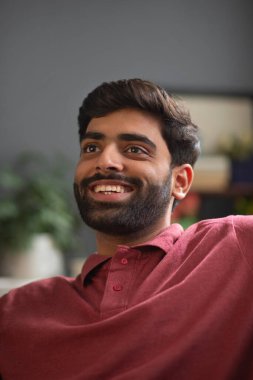 Sakallı neşeli genç adamın yakın plan portresi.