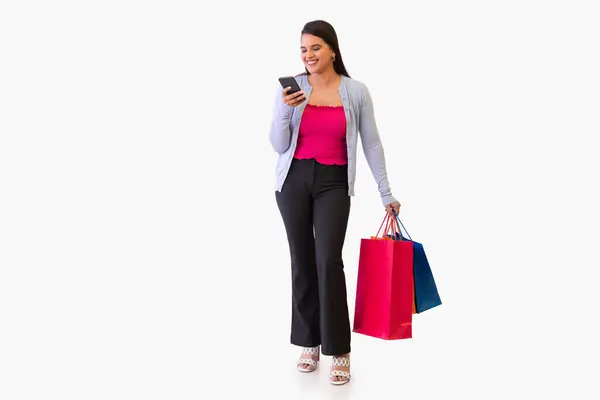 stock image Indian young girl watching smartphone while holding shopping bags in her hand