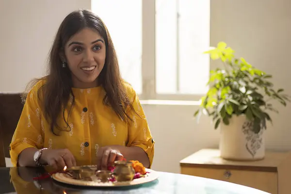 stock image Young woman arranging puja thali on the occasion of Rakshabanddhan