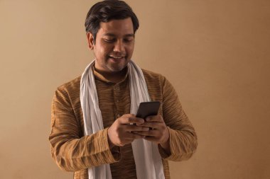 A RURAL MAN HAPPILY USING MOBILE PHONE clipart