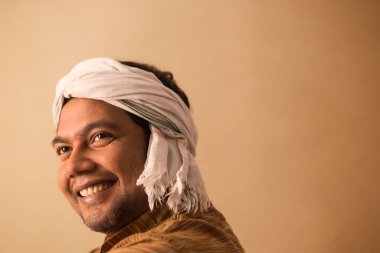 A RURAL MAN WITH DHOTI WRAPPED AROUND HIS HEAD LOOKING ABOVE AND SMILING clipart