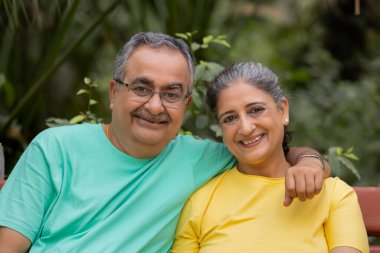 PORTRAIT OF A HAPPY COUPLE SITTING TOGETHER clipart