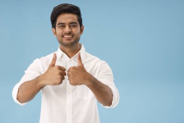 A HAPPY MAN SHOWING THUMBS UP IN FRONT OF CAMERA clipart