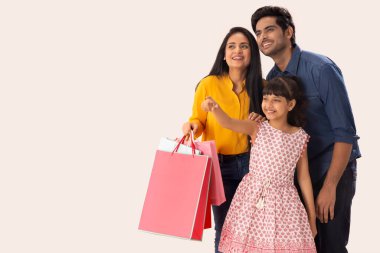 GENÇ KIZ BİR KIZ, ebeveynleriyle birlikte ayakta dururken MUTLULUĞU KURUYOR