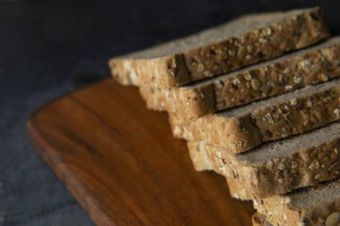 Doğranmış tahtada taze kepekli ekmek dilimleri