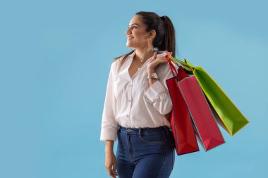 A young woman standing with Carrybags. clipart