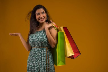 A young woman standing with Carrybags. clipart