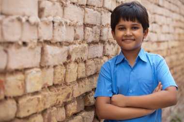 PORTRAIT OF A SMALL RURAL BOY LOOKING AT CAMERA AND SMILING clipart