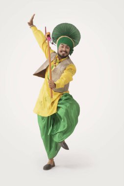 A Bhangra Dancer performing with a Kato. clipart