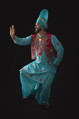 A Bhangra Dancer performing a dance step with hand gestures. clipart