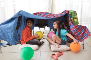 brother and sister camping at home clipart