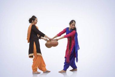 Two  Women Dancing with Earthen Pot clipart