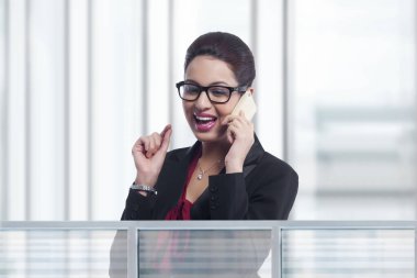 Portrait of beautiful call center representative greeting in office clipart