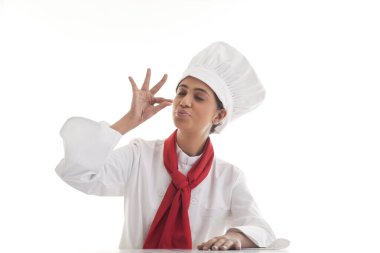 Kadın şef lezzeti simgelemek için eli ağzının önünde bahşiş veriyor.