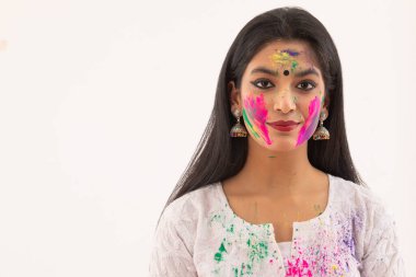 PORTRAIT OF A YOUNG WOMAN WITH HOLI COLOURS ON HER FACE clipart