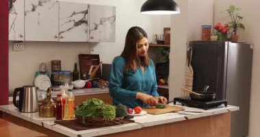 Mutfakta sebzeleri doğrayan kadın.