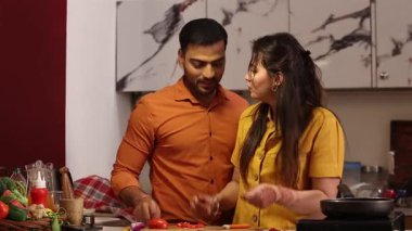 Bir çift, evde mutfakta akşam yemeği için hammadde ve sebze hazırlıyor. 