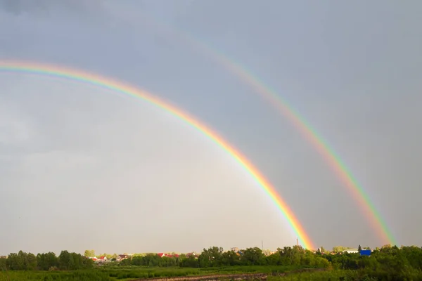 stock image Rainbow in sky clouds over rural house lawn summer field country landscape