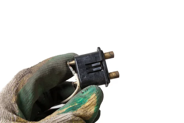 stock image An old car connector or trailer for closing an electrical circuit that a mechanic holds in gloves during repairs.