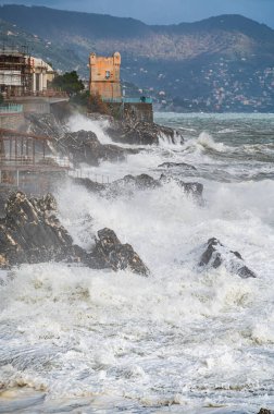 Waves on the promenade on the cliffs of Nervi, in the outskirts of Genoa, Italy