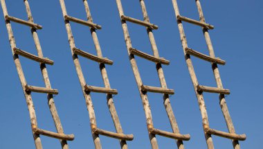 Old wooden ladder leading high up in the sky 