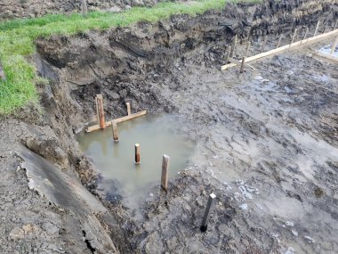 Flooded trench prepared for the construction of foundations clipart