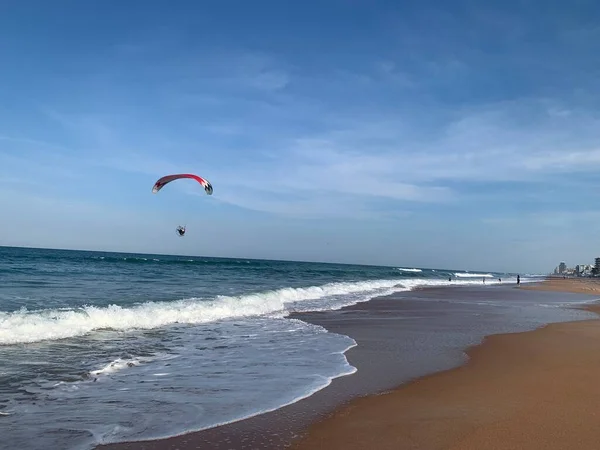 Parachute flying over ocean 