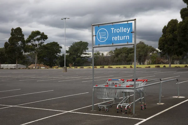 Trolley return station stands in an empty car park, offering a convenient spot for returning shopping carts.