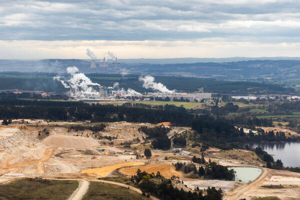 The industrial landscape is marked by the presence of an open-cast quarry and a paper mill in the distance.