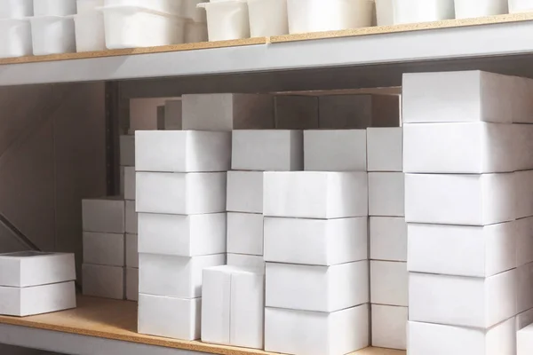 White boxes arranged in a cold storage unit, showcasing efficient storage system.